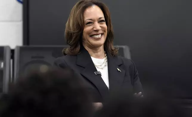 Democratic presidential nominee Vice President Kamala Harris speaks to marching band members at Liberty County High School in Hinesville, Ga., Wednesday, Aug. 28, 2024. (AP Photo/Jacquelyn Martin)