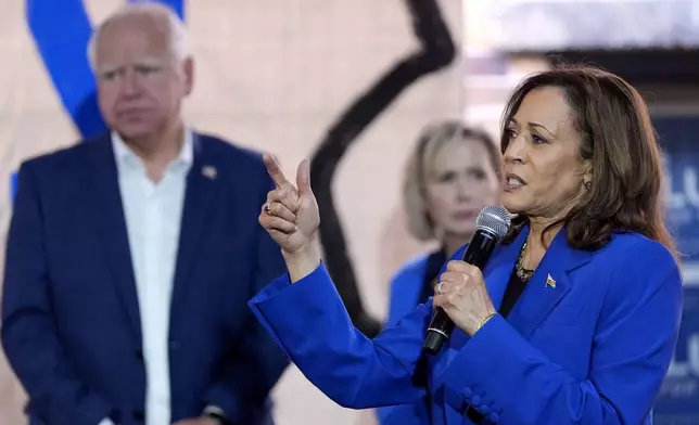 Democratic presidential nominee Vice President Kamala Harris, right, speaks as Democratic vice presidential nominee Minnesota Gov. Tim Walz, left, and his wife Gwen Walz listen at a campaign event, Sunday, Aug. 18, 2024, in Rochester, Pa. (AP Photo/Julia Nikhinson)