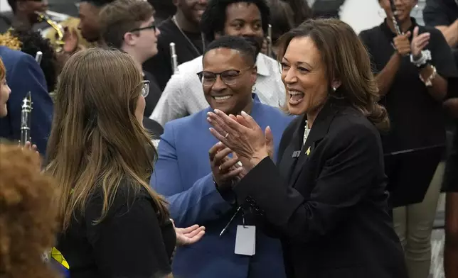 Democratic presidential nominee Vice President Kamala Harris speaks to marching band members at Liberty County High School in Hinesville, Ga., Wednesday, Aug. 28, 2024. (AP Photo/Jacquelyn Martin)