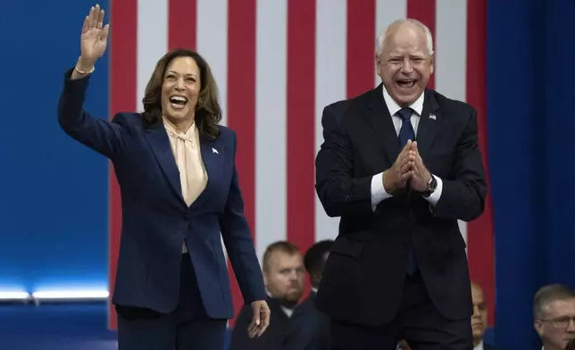 Democratic presidential nominee Vice President Kamala Harris and her running mate Minnesota Gov. Tim Walz arrive at a campaign rally in Philadelphia, Tuesday, Aug. 6, 2024. (AP Photo/Joe Lamberti)