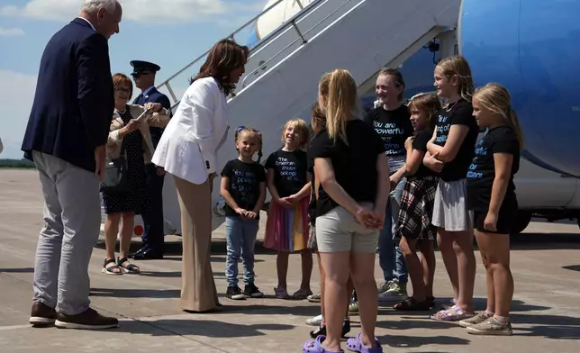 Democratic presidential nominee Vice President Kamala Harris and her running mate Minnesota Gov. Tim Walz greet children at Chippewa Valley Regional Airport, Wednesday, Aug. 7, 2024, in Eau Claire, Wis. (AP Photo/Julia Nikhinson)