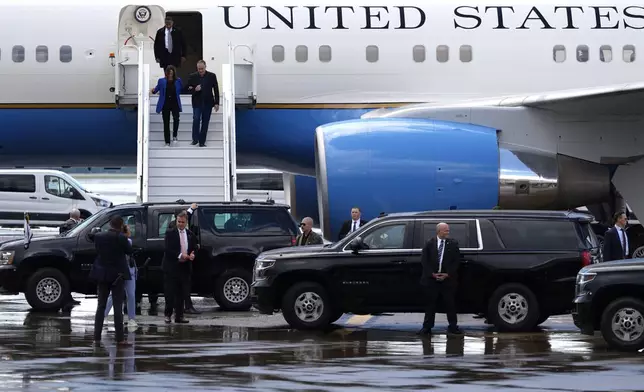 Democratic presidential nominee Vice President Kamala Harris, left, and second gentleman Doug Emhoff disembark from Air Force Two at Pittsburgh International Airport, Sunday, Aug. 18, 2024, in Pittsburgh. (AP Photo/Julia Nikhinson)