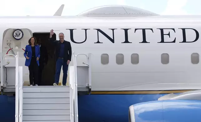 Democratic presidential nominee Vice President Kamala Harris, left, and second gentleman Doug Emhoff disembark from Air Force Two at Pittsburgh International Airport, Sunday, Aug. 18, 2024, in Pittsburgh. (AP Photo/Julia Nikhinson)