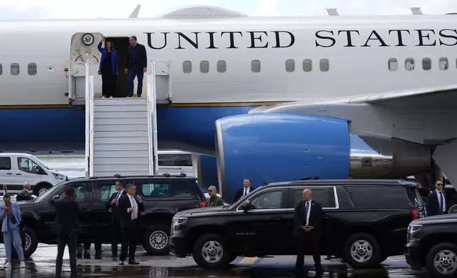 Democratic presidential nominee Vice President Kamala Harris, left, and second gentleman Doug Emhoff disembark from Air Force Two at Pittsburgh International Airport, Sunday, Aug. 18, 2024, in Pittsburgh. (AP Photo/Julia Nikhinson)