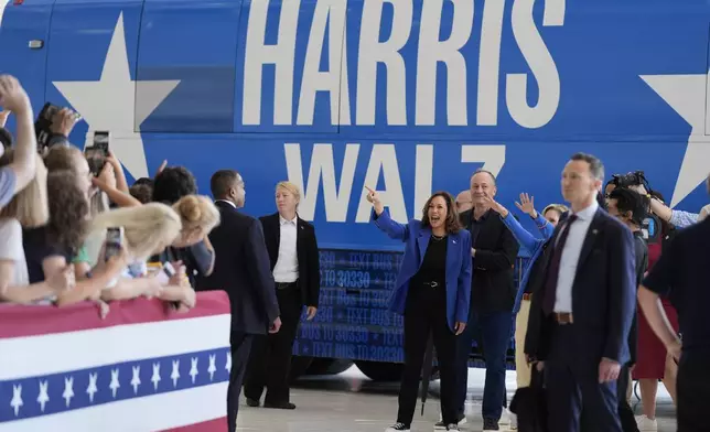 Democratic presidential nominee Vice President Kamala Harris, center, and second gentleman Doug Emhoff greet supporters upon arriving at Pittsburgh International Airport, Sunday, Aug. 18, 2024, in Pittsburgh. (AP Photo/Julia Nikhinson)