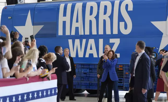 Democratic presidential nominee Vice President Kamala Harris claps alongside second gentleman Doug Emhoff as they greet supporters at Pittsburgh International Airport, Sunday, Aug. 18, 2024, in Pittsburgh. (AP Photo/Julia Nikhinson)