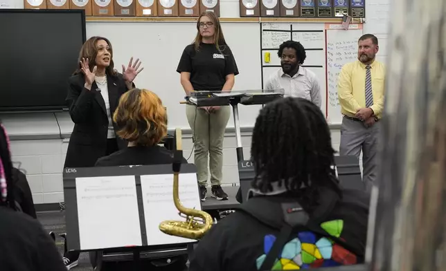 Democratic presidential nominee Vice President Kamala Harris speaks to marching band members at Liberty County High School in Hinesville, Ga., Wednesday, Aug. 28, 2024. (AP Photo/Jacquelyn Martin)