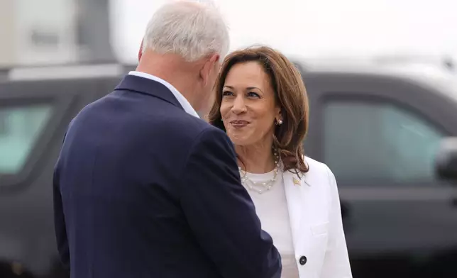 Democratic presidential nominee Vice President Kamala Harris and her running mate Minnesota Gov. Tim Walz talk before they board Air Force Two at Chippewa Valley Regional Airport, Wednesday, Aug. 7, 2024, in Eau Claire, Wis. (AP Photo/Julia Nikhinson)