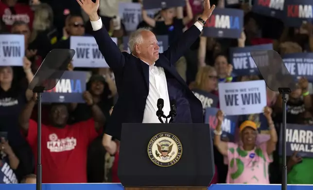 Democratic vice presidential candidate Minnesota Gov. Tim Walz speaks at a campaign rally Wednesday, Aug. 7, 2024, in Romulus, Mich., with Democratic presidential nominee Vice President Kamala Harris. (AP Photo/Carlos Osorio)