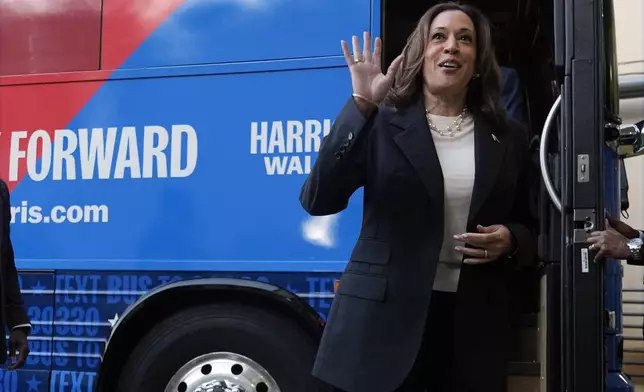 Democratic presidential nominee Vice President Kamala Harris waves as she exits her campaign bus in Savannah, Ga., Wednesday, Aug. 28, 2024. (AP Photo/Jacquelyn Martin)