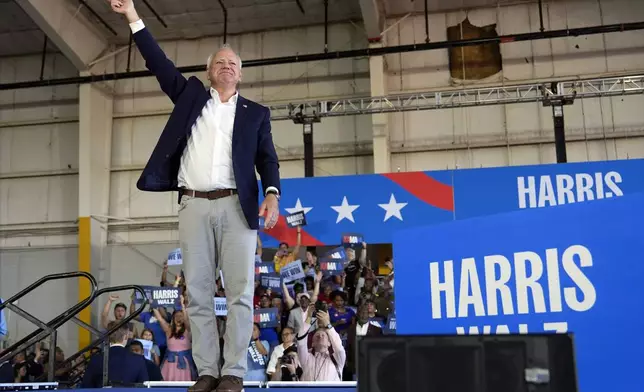 Democratic vice presidential candidate Minnesota Gov. Tim Walz arrives to speak at a campaign rally Wednesday, Aug. 7, 2024, in Romulus, Mich., before Democratic presidential nominee Vice President Kamala Harris. (AP Photo/Julia Nikhinson)