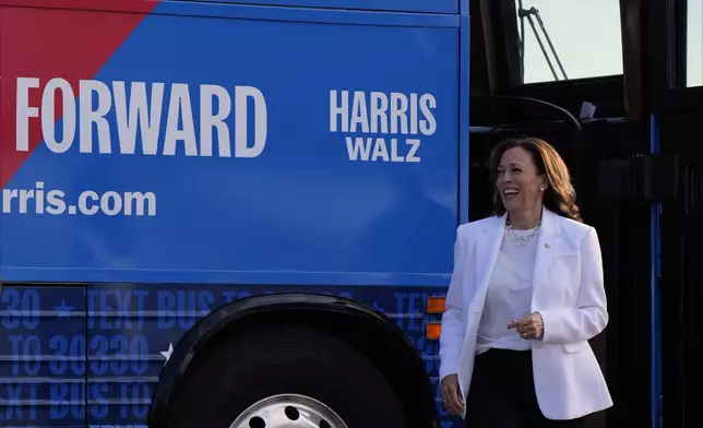 Democratic presidential nominee Vice President Kamala Harris steps off her campaign bus at Savannah/Hilton Head International Airport in Savannah, Ga., Thursday, Aug. 29, 2024, after a bus tour and campaign rally. (AP Photo/Jacquelyn Martin)