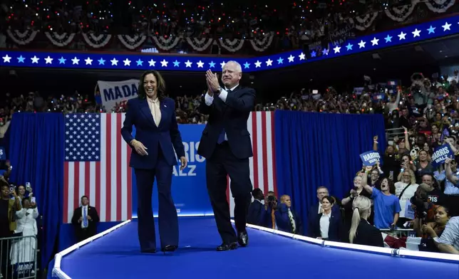 Democratic presidential nominee Vice President Kamala Harris and her running mate Minnesota Gov. Tim Walz arrive at a campaign rally in Philadelphia, Tuesday, Aug. 6, 2024. (AP Photo/Matt Rourke)