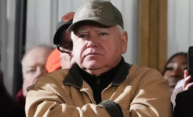 FILE - Minnesota Gov. Tim Walz listens as President Joe Biden speaks at Dutch Creek Farms in Northfield, Minn., Nov. 1, 2023. (AP Photo/Andrew Harnik, File)