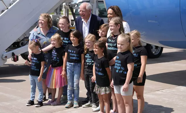 Democratic presidential nominee Vice President Kamala Harris and her running mate Minnesota Gov. Tim Walz pose for a photo after arriving at Chippewa Valley Regional Airport, Wednesday, Aug. 7, 2024, in Eau Claire, Wis. (AP Photo/Julia Nikhinson)