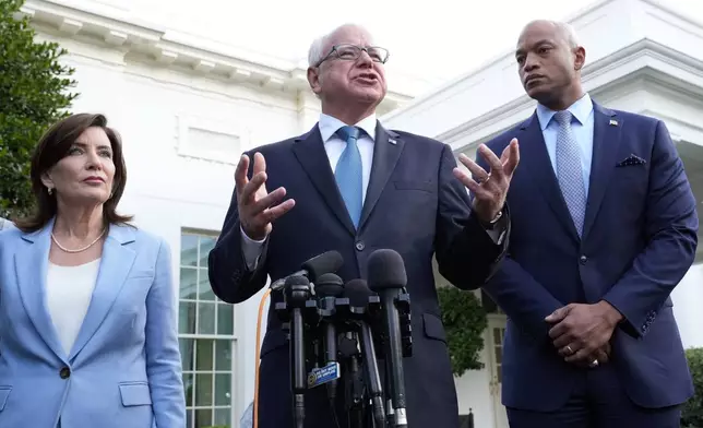 FILE - Minnesota Gov. Tim Walz, center, standing with New York Gov. Kathy Hochul, left, and Maryland Gov. Wes Moore, right, talks with reporters following their meeting with President Joe Biden at the White House in Washington, July 3, 2024. (AP Photo/Susan Walsh, File)