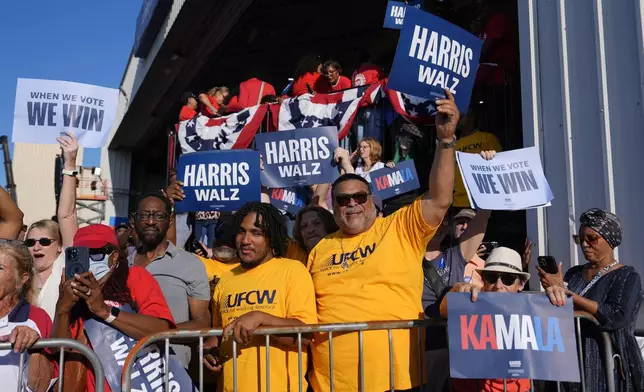 Supporters cheer as Democratic presidential nominee Vice President Kamala Harris and Democratic vice presidential candidate Minnesota Gov. Tim Walz arrive at a campaign rally Wednesday, Aug. 7, 2024, in Romulus, Mich. (AP Photo/Julia Nikhinson)