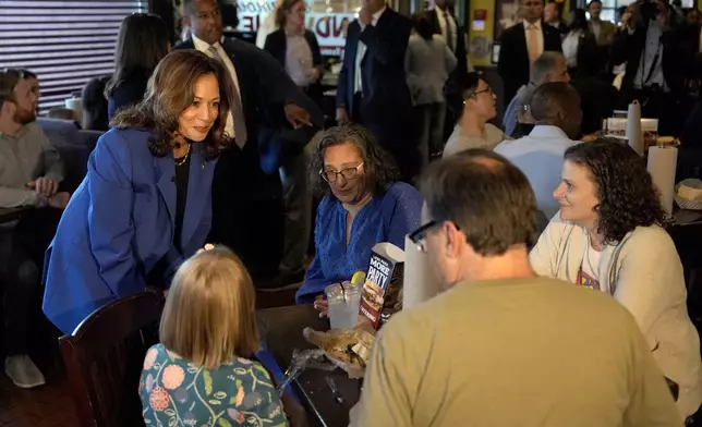 Democratic presidential nominee Vice President Kamala Harris, left, greets customers at Primanti Bros. restaurant during a campaign stop, Sunday, Aug. 18, 2024, in Pittsburgh. (AP Photo/Julia Nikhinson)