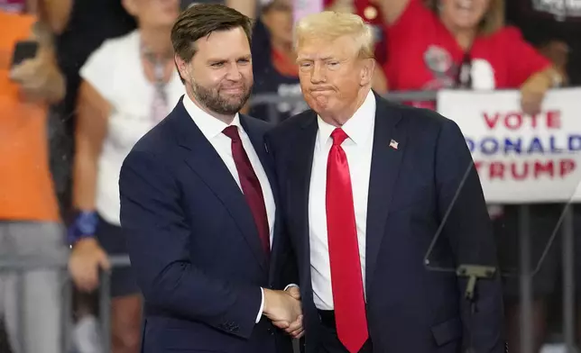 FILE - Republican vice presidential candidate Sen. JD Vance, R-Ohio, left, and Republican presidential candidate former President Donald Trump, shake hands at a campaign rally in Atlanta, Aug. 3, 2024. (AP Photo/Ben Gray, File)