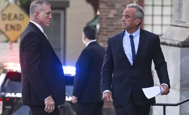 Independent presidential candidate Robert F. Kennedy Jr.,right, turns to look at supporters as he arrives at the Albany County Courthouse to fight a lawsuit he falsely claimed to live in New York state, Wednesday, Aug. 7, 2024, in Albany, N.Y. (AP Photo/Hans Pennink)