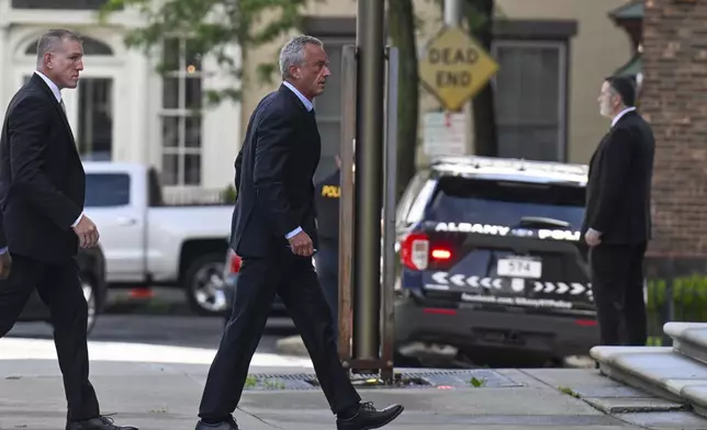 Independent presidential candidate Robert F. Kennedy Jr., right, arrives at the Albany County Courthouse to fight a lawsuit he falsely claimed to live in New York state, Wednesday, Aug. 7, 2024, in Albany, N.Y. (AP Photo/Hans Pennink)