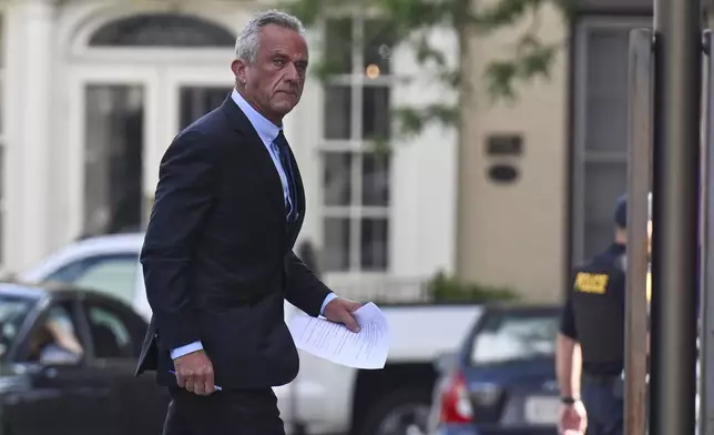 Independent presidential candidate Robert F. Kennedy Jr., right, arrives at the Albany County Courthouse to fight a lawsuit he falsely claimed to live in New York state, Wednesday, Aug. 7, 2024, in Albany, N.Y. (AP Photo/Hans Pennink)