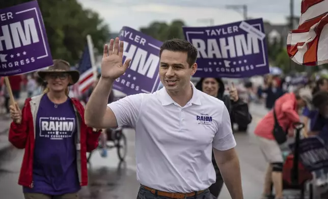 Republican Second Congressional District candidate Tayler Rahm campaigns at the Eagan Fun Fest Parade in Eagan, Minn., Thursday, July 4, 2024. (Jerry Holt/Star Tribune via AP)