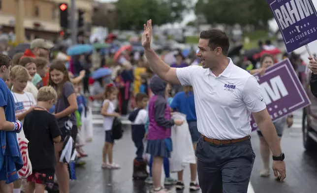 Republican Second Congressional District candidate Tayler Rahm campaigns at the Eagan Fun Fest Parade in Eagan, Minn., Thursday, July 4, 2024. (Jerry Holt/Star Tribune via AP)