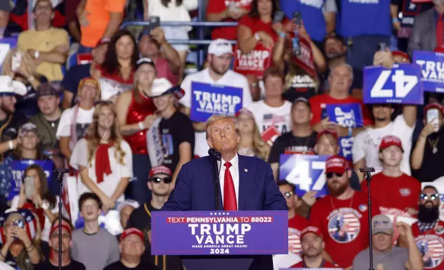 Republican presidential nominee former President Donald Trump looks up at a campaign video at a campaign rally at the Mohegan Sun Arena at Casey Plaza in Wilkes-Barre, Pa., Saturday, Aug. 17, 2024. (AP Photo/Laurence Kesterson)