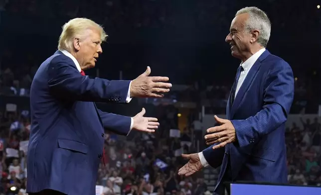 Republican presidential nominee former President Donald Trump greets Independent presidential candidate Robert F. Kennedy Jr. at a campaign rally at the Desert Diamond Arena, Friday, Aug. 23, 2024, in Glendale, Ariz. (AP Photo/Evan Vucci)