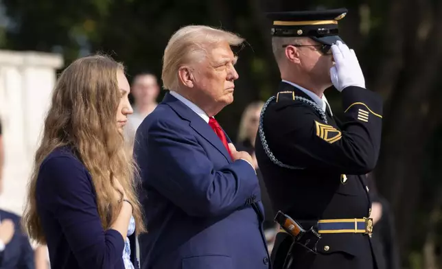 Misty Fuoco, left, sister of Nicole Gee, and Republican presidential nominee former President Donald Trump place their hands over their heart after placing a wreath in honor of Sgt. Nicole Gee, at the Tomb of the Unknown Solider at Arlington National Cemetery, Monday, Aug. 26, 2024, in Arlington, Va. (AP Photo/Alex Brandon)