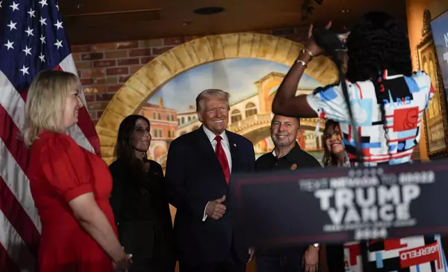 Republican presidential nominee former President Donald Trump poses for a photo at a campaign event at ll Toro E La Capra, Friday, Aug. 23, 2024, in Las Vegas. Second from right is restaurant owner Javier Barajas.(AP Photo/Julia Nikhinson)