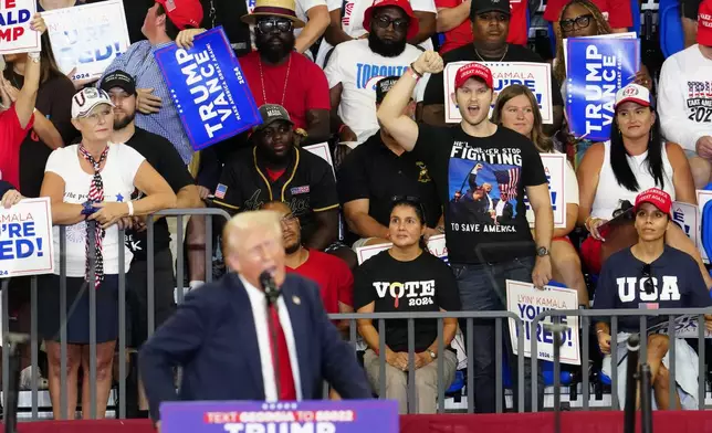 Supporters listen as Republican presidential candidate former President Donald Trump speaks at a campaign rally at Georgia State University in Atlanta, Saturday, Aug. 3, 2024. (AP Photo/Ben Gray)