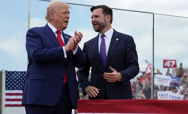 Republican presidential nominee former President Donald Trump and Republican vice presidential nominee Sen. JD Vance, R-Ohio, stand on stage at a campaign rally at North Carolina Aviation Museum, Wednesday, Aug. 21, 2024, in Asheboro, N.C. (AP Photo/Julia Nikhinson)