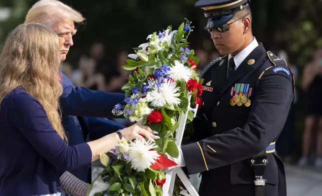 Misty Fuoco, left, sister of Nicole Gee, and Republican presidential nominee former President Donald Trump place a wreath in honor of Sgt. Nicole Gee, at the Tomb of the Unknown Solider at Arlington National Cemetery, Monday, Aug. 26, 2024, in Arlington, Va. (AP Photo/Alex Brandon)