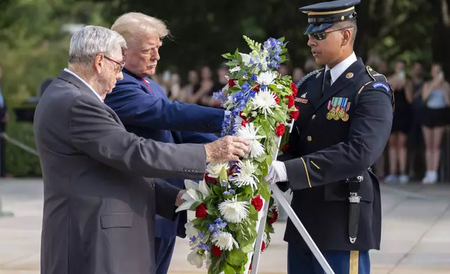 Bill Barnett, left, grandfather of Darin Taylor Hoover, and Republican presidential nominee former President Donald Trump place a wreath at the Tomb of the Unknown Solider in honor of Staff Sgt. Darin Taylor Hoover at Arlington National Cemetery, Monday, Aug. 26, 2024, in Arlington, Va. (AP Photo/Alex Brandon)