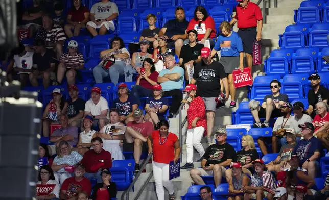 Attendees depart as Republican presidential candidate former President Donald Trump speaks at a campaign rally at Georgia State University in Atlanta, Saturday, Aug. 3, 2024. (AP Photo/Ben Gray)