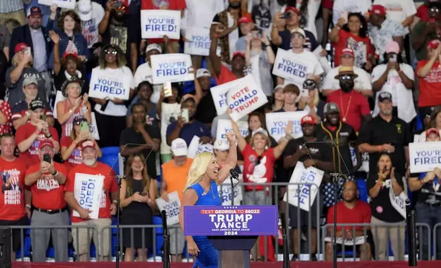 Rep. Marjorie Taylor Greene, R-Ga., arrives to speak at a campaign rally for Republican presidential candidate former President Donald Trump at Georgia State University in Atlanta, Saturday, Aug. 3, 2024. (AP Photo/John Bazemore)