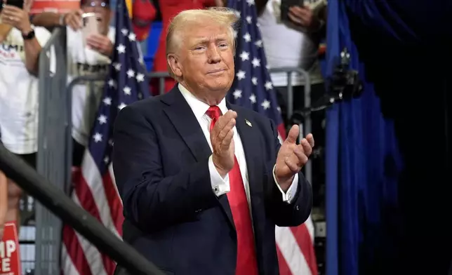 Republican presidential candidate former President Donald Trump claps at a campaign rally at Georgia State University in Atlanta, Saturday, Aug. 3, 2024. (AP Photo/John Bazemore)