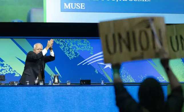 Democratic vice presidential nominee Minnesota Gov. Tim Walz acknowledges the cheering crowd after speaking at the American Federation of State, County and Municipal Employees (AFSCME) Convention in Los Angeles, Tuesday, Aug. 13, 2024. (AP Photo/Jae C. Hong)