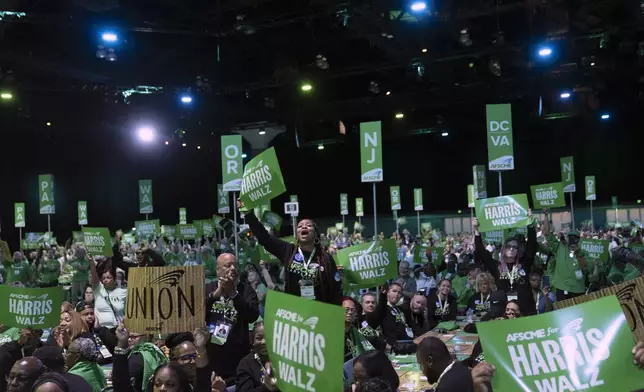 Attendees cheer as they listen to Democratic vice presidential nominee Minnesota Gov. Tim Walz speak at the American Federation of State, County and Municipal Employees (AFSCME) Convention in Los Angeles, Tuesday, Aug. 13, 2024. (AP Photo/Jae C. Hong)