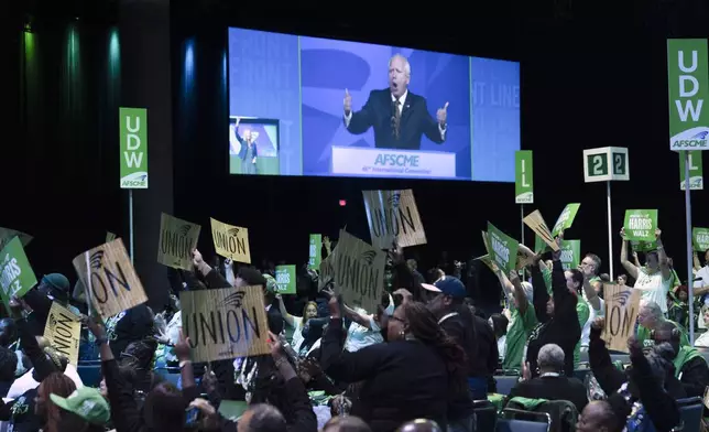 Attendees cheer as they listen to Democratic vice presidential nominee Minnesota Gov. Tim Walz speak at the American Federation of State, County and Municipal Employees (AFSCME) Convention in Los Angeles, Tuesday, Aug. 13, 2024. (AP Photo/Jae C. Hong)