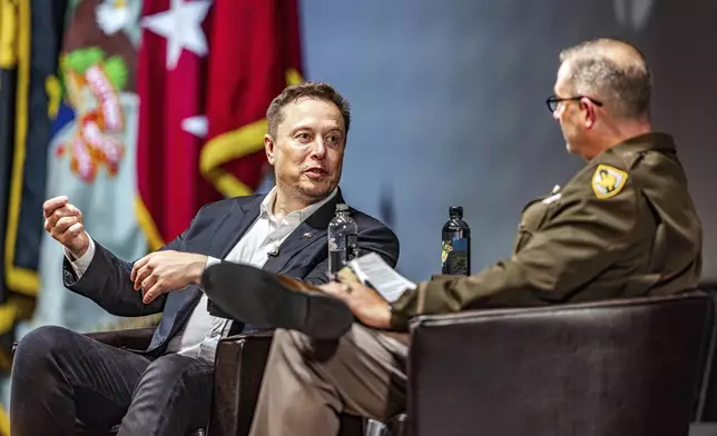 In this image provided by U.S. Military Academy at West Point, Friday, Aug. 16, 2024, Elon Musk, left, speaks his fireside chat with Brig. Gen Shane Reeves, Dean of the Academic Board at the U.S. Military Academy, as part of the academic year's intellectual theme, "The Human and the Machine: Leadership on the Emerging Battlefield," in West Point, N.Y. (U.S. Military Academy at West Point via AP)