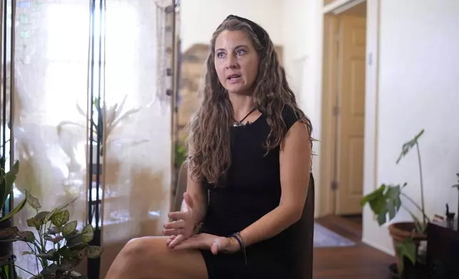 Kyleigh Thurman, one of the patients who is filing a federal complaint against an emergency room for not treating her ectopic pregnancy, talks about her experience at her studio, Wednesday, Aug. 7, 2024, in Burnet County, Texas. (AP Photo/Eric Gay)