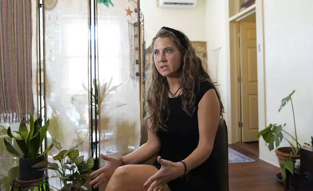 Kyleigh Thurman, one of the patients who is filing a federal complaint against an emergency room for not treating her ectopic pregnancy, talks about her experience at her studio, Wednesday, Aug. 7, 2024, in Burnet County, Texas. (AP Photo/Eric Gay)