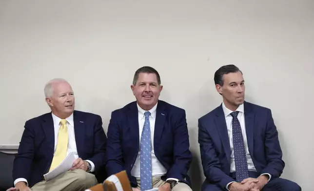 Santee Cooper CEO Jimmy Staton, left, Dominion Energy South Carolina President Keller Kissam, center, and Duke Energy's utility operations in South Carolina President Mike Callahan, right, wait to testify before a South Carolina Senate committee planning to write a comprehensive energy bill in 2025 in Columbia, S.C., on Thursday, Aug. 22 2024. (AP Photo/Jeffrey Collins)