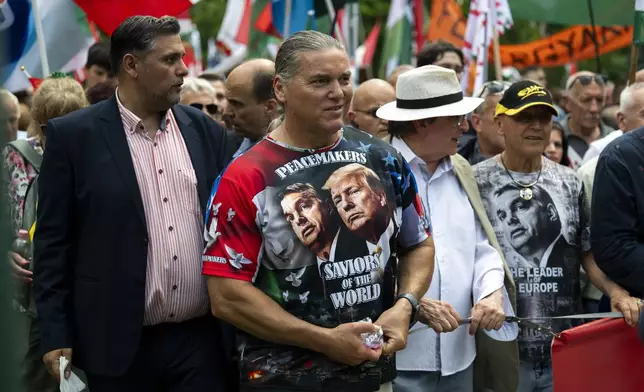 FILE -A man wearing a T-shirt showing Viktor Orban and Donald Trump, attends a "peace march" in support of Prime Minister Viktor Orbán and his party in Budapest, Hungary on June 1, 2024. (AP Photo/Denes Erdos, File)