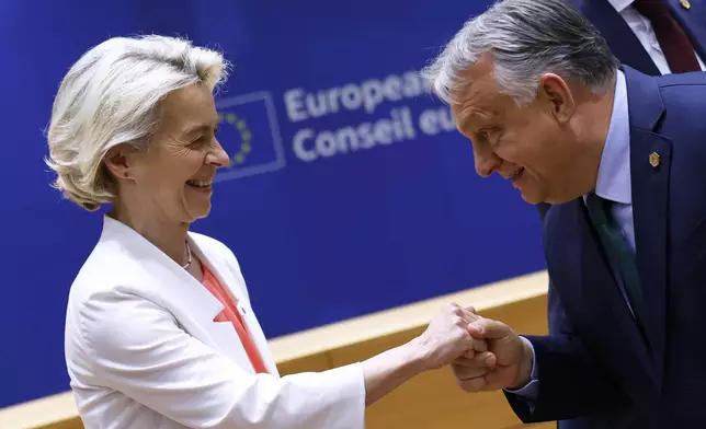 FILE- European Commission President Ursula von der Leyen, left, is greeted by Hungary's Prime Minister Viktor Orban during a round table meeting at an EU summit in Brussels, June 17, 2024. (AP Photo/Geert Vanden Wijngaert, File)