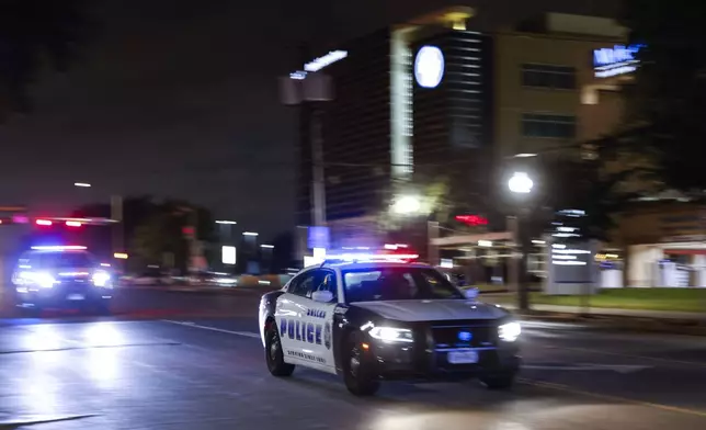 Dallas Police Department officers carry a procession along Colorado Blvd. towards Dallas County Medical Examiner following the death of a Dallas police officer on Thursday night, at Methodist Dallas Medical Center in Dallas, Friday, Aug. 30, 2024. (Shafkat Anowar/The Dallas Morning News via AP)