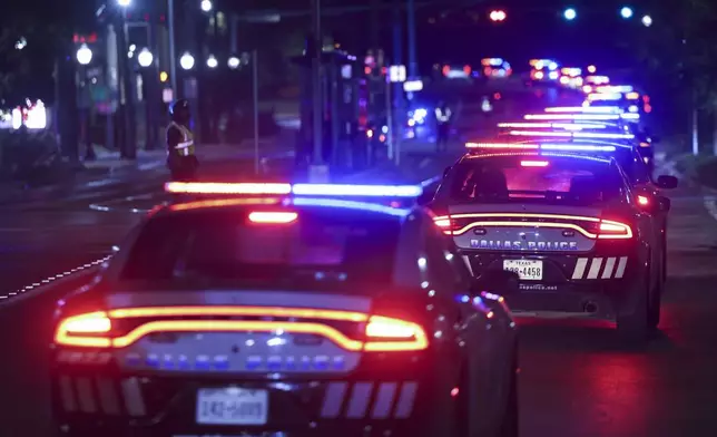 Dallas Police Department officers carry a procession along Colorado Blvd. towards Dallas County Medical Examiner following the death of a Dallas police officer on Thursday night, at Methodist Dallas Medical Center in Dallas, Friday, Aug. 30, 2024. (Shafkat Anowar/The Dallas Morning News via AP)